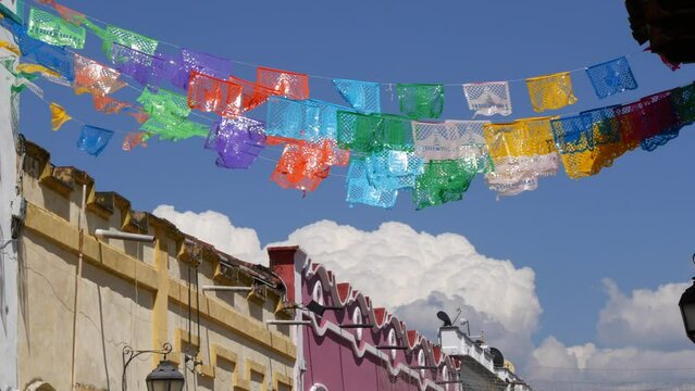 Colorful mexican perforated papel picado banner, festival colourful paper garland. Multi colored hispanic folk carved tissue flags, holiday or carnival. Authentic fiesta decoration in Latin America.