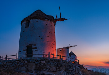 Traditional windmills in Vivlos village at dusk, Naxos island GR