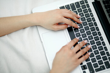 Fototapeta na wymiar Close up of female hands pressing keys of laptop keypad.