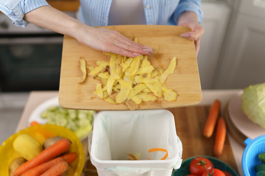 Woman Throwing Away Potato Peels For Recycling. Female Composting Organic Waste At Home. Person Put Food Leftovers Into Bokashi Bin For Fermentation