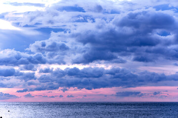 Fototapeta premium Majestic dramatic sunset sky with large and dark rain clouds in evening time over the Andaman Sea in Langkawi island, Malaysia