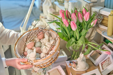Easter Delights: Woman Holding a Basket of Bunny and Egg-shaped Candles