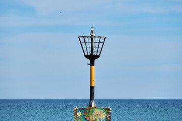 Light beacon on a pole in the sea