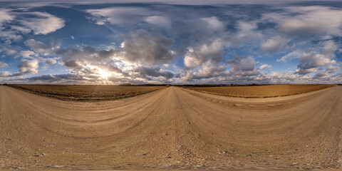 360 hdri panorama on gravel road with evening clouds on blue sky before sunset in equirectangular spherical seamless projection, use as sky replacement in drone panoramas, game development as sky dome
