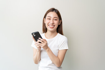 Happy Asian woman holding a smartphone and winning the prize.