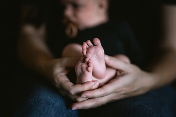 Parents holding their baby's feet. Parental love. Newborn.