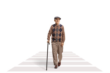 Full length portrait of an elderly man with a cane walking at a pedestrian crossing