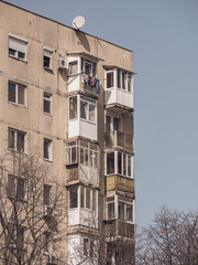 Worn out apartment building from the communist era against blue sky in Bucharest Romania. Ugly traditional communist housing ensemble