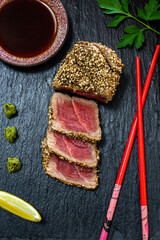 Detail of sesame seared ahi tuna on black slate