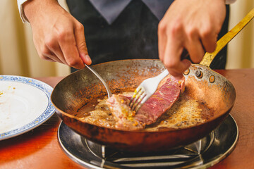 cooking meat in a pan