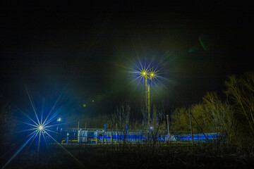 gas station behind the fence at night with light