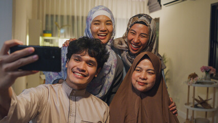 Happy Asian muslim family greeting celebrate long distance with cousin use cell phone video call...