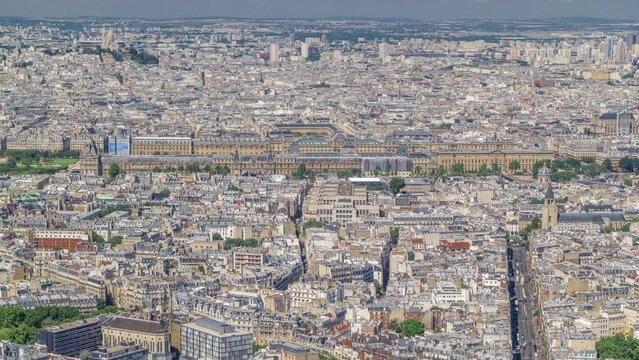 Top view of Paris skyline with traffic on street intersection from above timelapse. Main landmarks of european megapolis. Bird-eye view from observation deck of Montparnasse tower. Paris, France