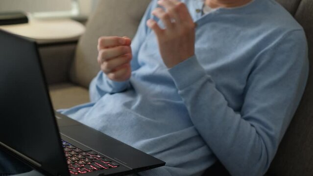 Sign language interpreter or deaf mute man communicates in sign language in video chat, close up
