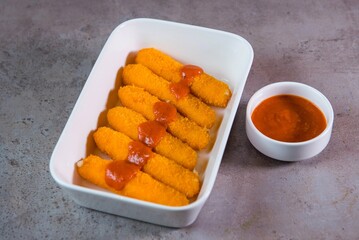 Mozzarella Sticks with ketchup served in dish isolated on grey background top view of bahrain food