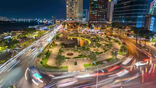 Traffic in front of Tran Hung Dao roundabout near Bach Dang port and Saigon river at twilight in Ho Chi Minh city, Vietnam. Hyper lapse.