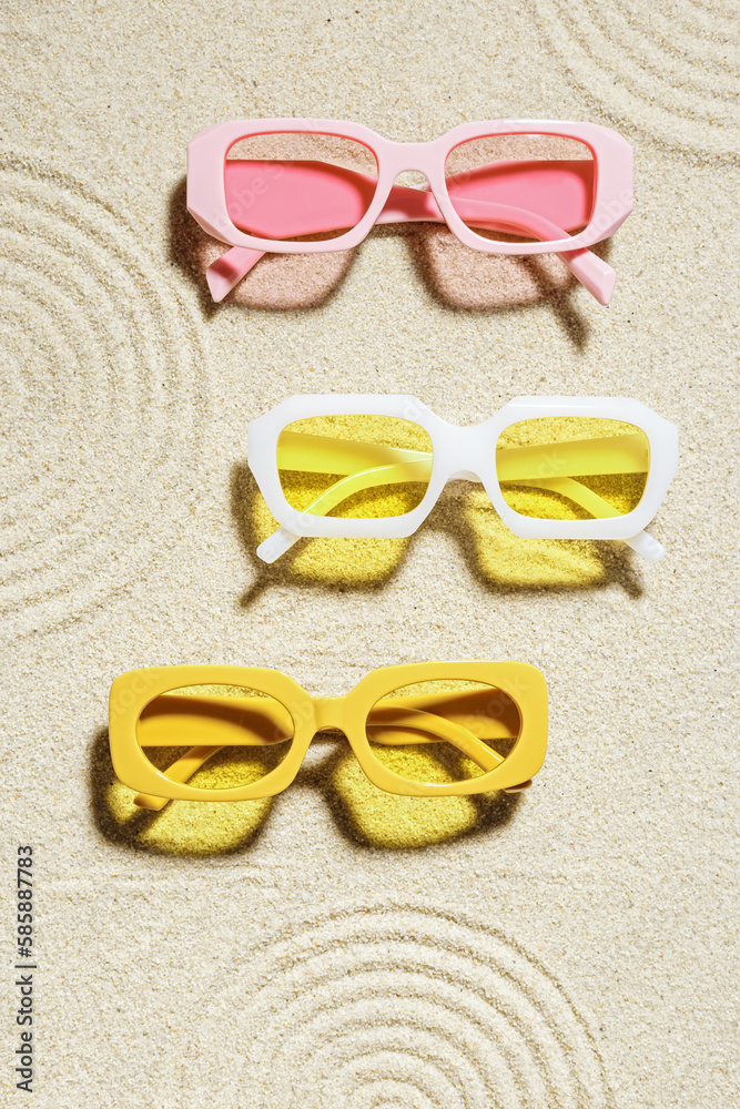 Wall mural set of colorful sunglasses on sand background zen .japanese garden at sunlight with shadow. summer f