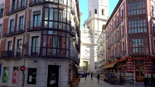 Valladolid, Spain - November 12 2022:  Spectacular city center of Valladolid with beautiful architecture style and colourful buildings. Cathedral tower in background. Stabilized video, tilt down