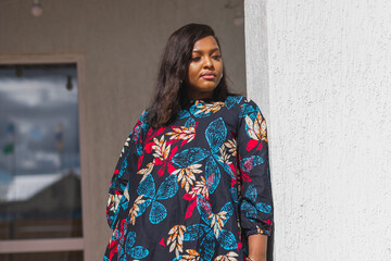 African american woman relaxing and enjoying sun while standing at terrace or balcony at sunlight at summer. Slow living and tranquil moment and mental health. Backyard terrace vacation weekend