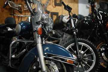 Fototapeta na wymiar Motorcycles range in garage shop, repaired motorbikes ready for selling