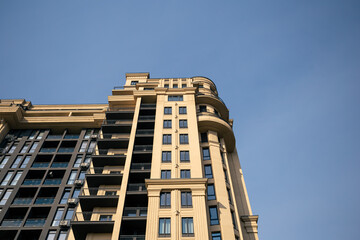 Fototapeta premium Facade of a multi-storey residential building against the sky, modern architecture, residential building.