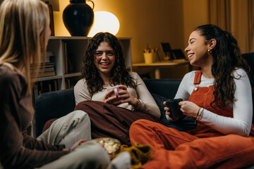 Three women are hanging out in the evening