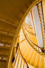Fototapeta premium Yellow spiral staircase.