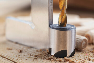 Countersink drill bit with steel triangle ruler make sink in hole for screw in wooden oak plank