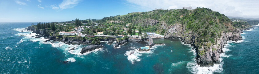 Fototapeta na wymiar Drone view of the Caloura natural swimming pool, located in a seaside fishing village with great views and a secluded beach in the Sao Miguel island in the Azores, Portugal