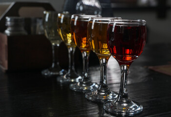 Glasses with wine. Different types of wine are poured into glasses. A set of alcoholic drinks in a restaurant.