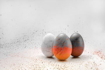 three egg with screative paint splatter