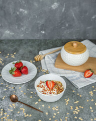 Healthy food concept: homemade granola with yogurt and strawberries. Oatmeal with freeze-dried strawberries, fresh berries and honey. Delicious and healthy breakfasts.
