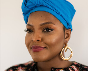 Beautiful african american girl wearing national turban headscarf over white wall background...