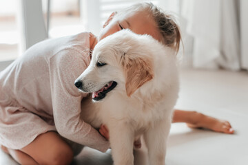 child girl play hugging dog puppy golden retriever, pet therapy and canisterapy for adults and...