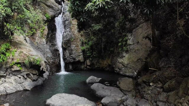 Cascada con agua cristalina rodeada de rocas en el bosque