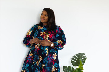 Portrait of african american woman smiling against white wall in room - inclusion and diversity...