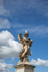 Fototapeta na wymiar Angel statue on a pedestal at Ponte Sant Angelo in Rome, Italy.