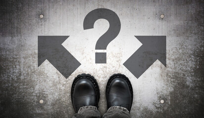 Heavy black leather boots, two arrows and question mark - problem concept