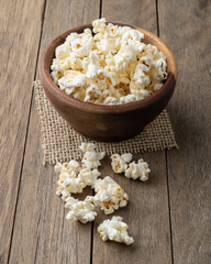 Popcorns on a bowl over wooden table