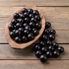 Jabuticabas on a bowl over wooden table