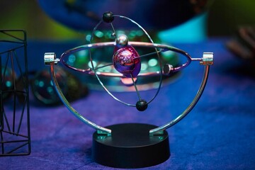 The image of a molecule in the form of a perpetual motion machine on a magnet. The concept of...