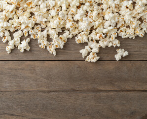 Popcorns over wooden table with copy space