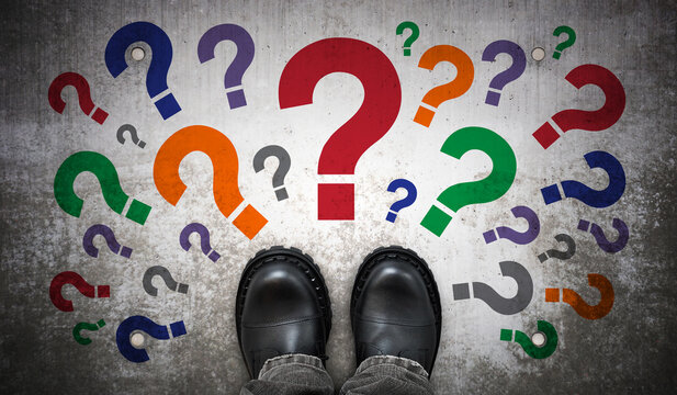 Heavy black leather boots and many colorful question marks - doubt concept