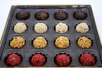 Multi-colored chocolates in dark packaging