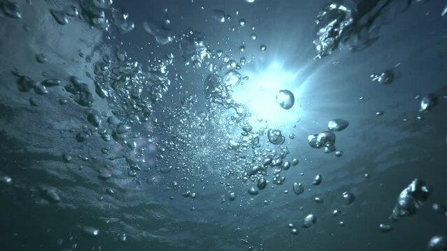 Underwater point of view of bubbles, they are floating to the water surface from below to the top, footage taken at Caribbean sea.