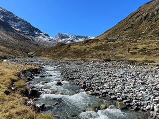 Mountain stream Aua da Grialetsch in the beautiful autumn setting of the alpine valley Val Grialetsch of the Albula Alps massif, Zernez - Canton of Grisons, Switzerland (Kanton Graubünden, Schweiz)