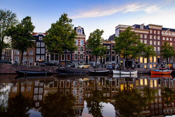 Amsterdam dancing houses and beautiful reflections at sunrise