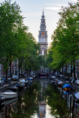 Naklejka premium Zuiderkerk church and reflection in canal, Amsterdam