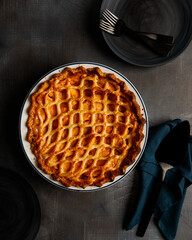 Pie on dark surface with lattice crust 