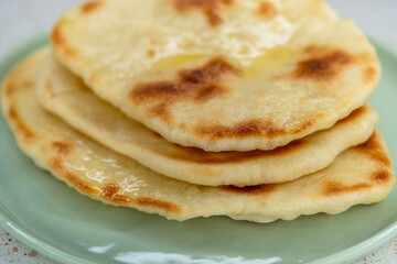 Homemade Indian Naan Flatbread made with Whole Wheat flour, with garlic and oil on top